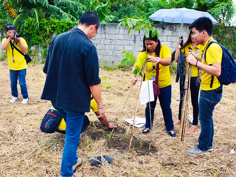 Profriends employees and Lancaster New City Cavite residents during a tree-planting activity.